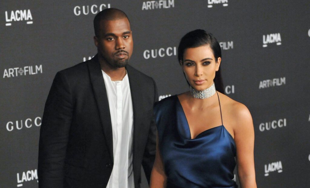 Kanye West in einer Jacke mit Kim Kardashian in einem Kleid